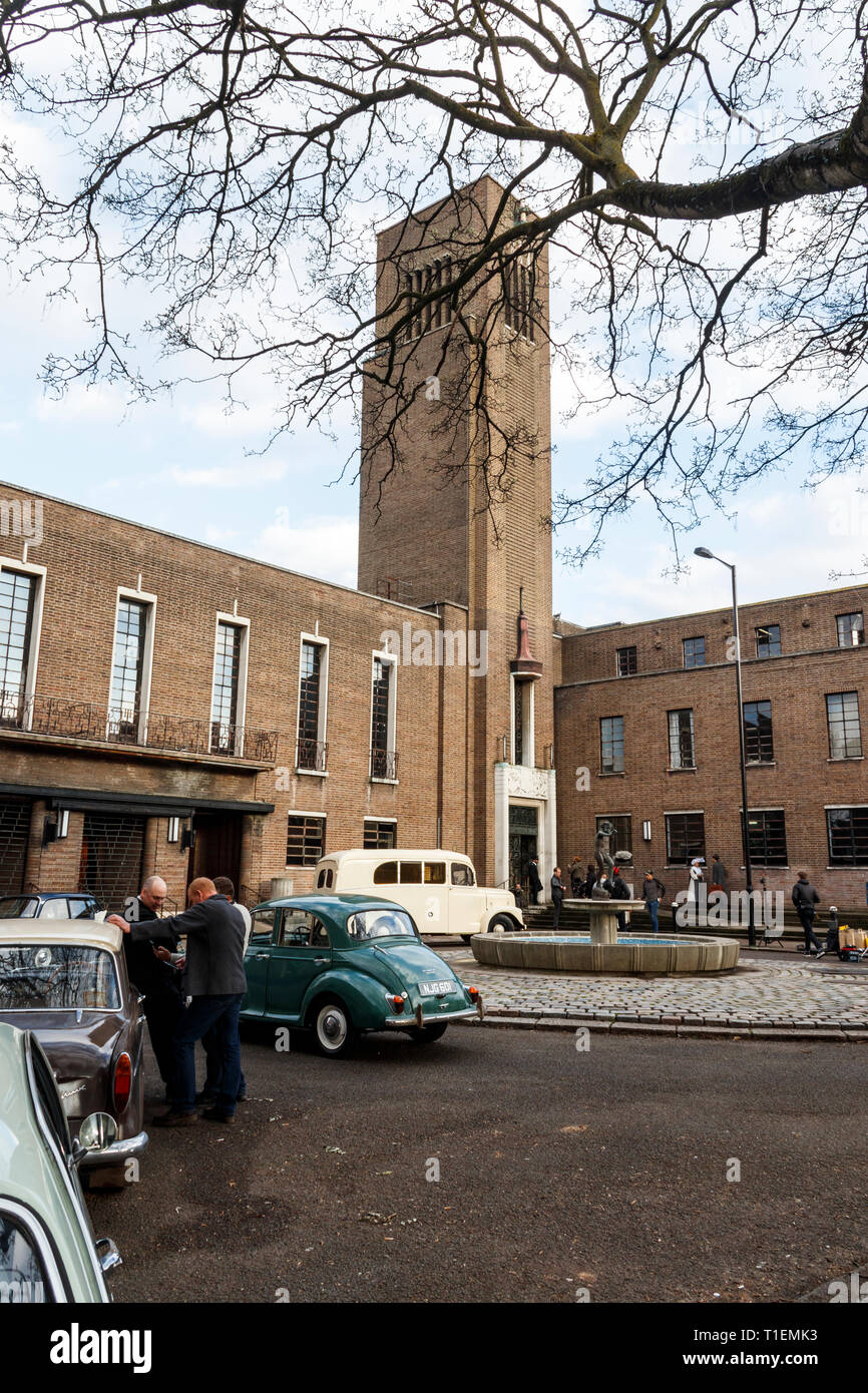 Crouch End, London, UK. 26th March 2019.  A production crew film a scene for 'Pennyworth', an upcoming American drama TV series featuring the early life of Batman's faithful butler Alfred. The art deco town hall is a popular location for film and TV productions. Credit: Michael Heath/Alamy Live News Stock Photo