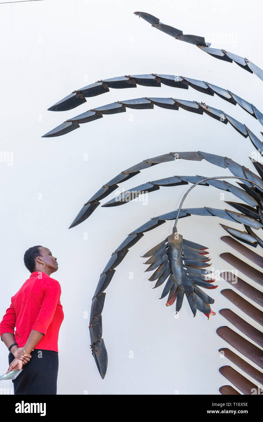 Miami Beach Florida,Bass Museum of Art,Federico Uribe,artist,sculpture,Traveler Palm,2002,metal,Black woman female women,looking,visitor,FL090310079 Stock Photo