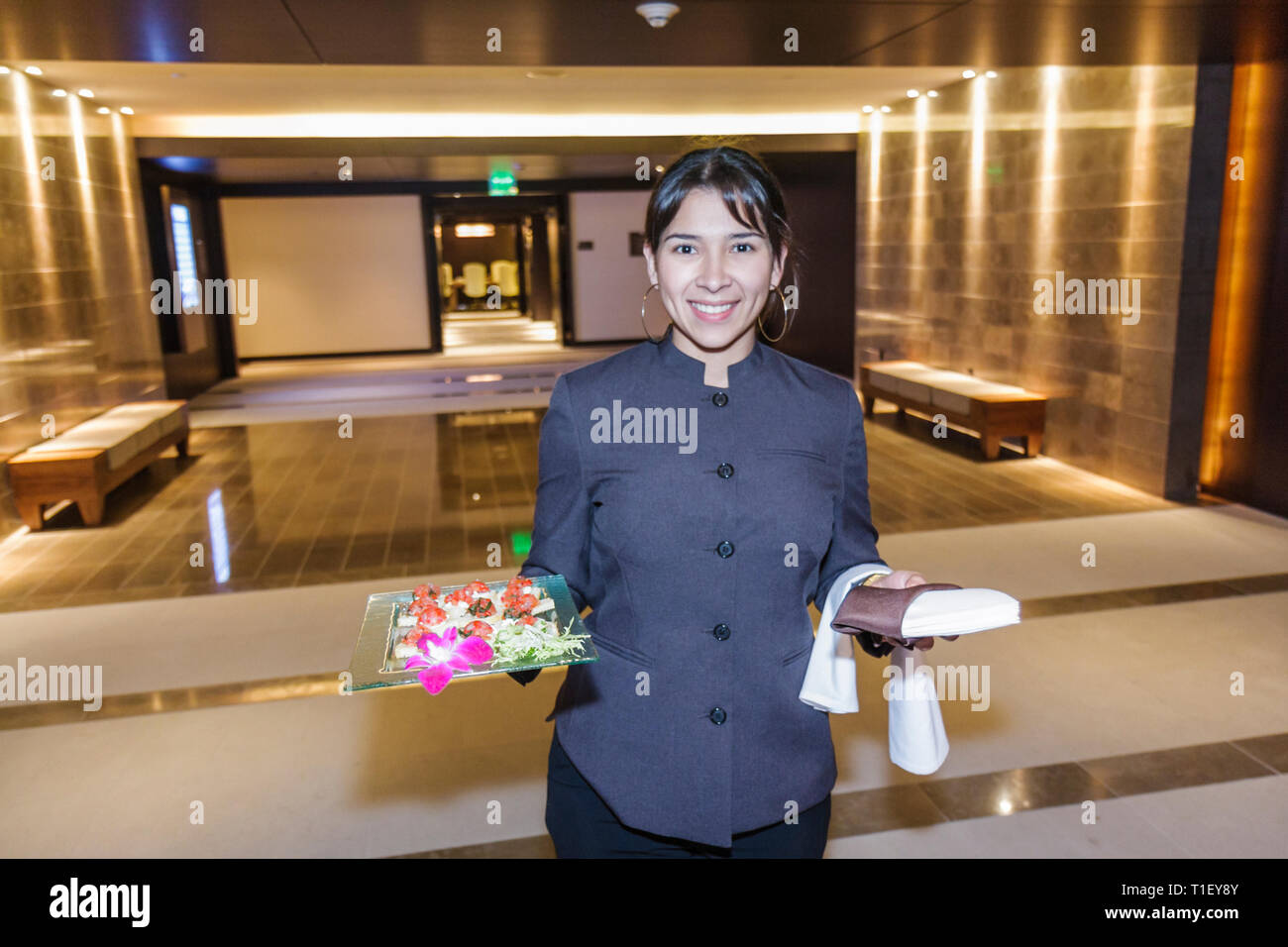 Miami Florida,Epic,hotel,luxury,boutique,hostess,working,work,employee worker workers staff,Hispanic woman female women,uniform,smiling,happy,hors d'o Stock Photo