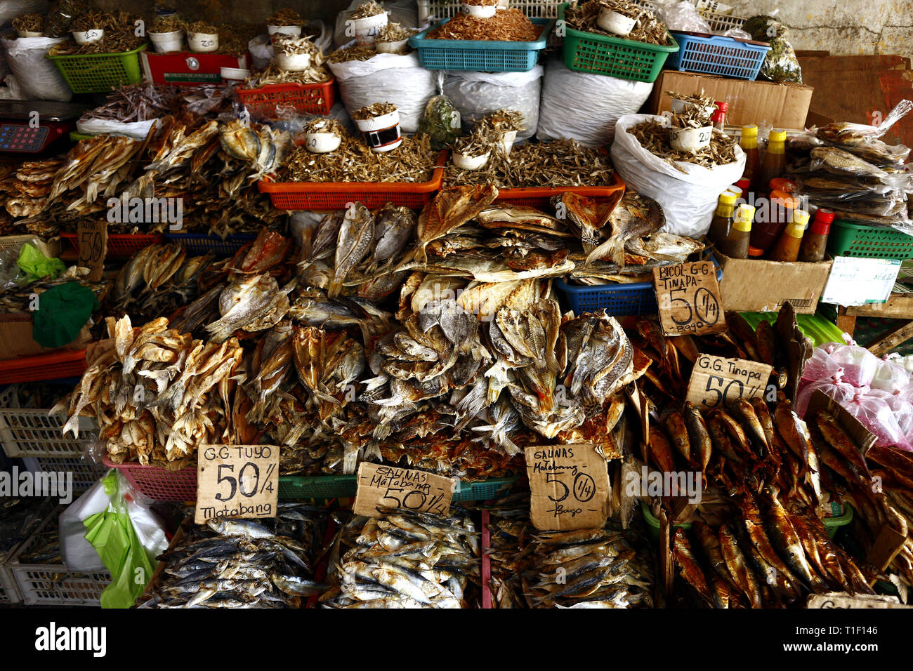 Photo of a variety of dried and smoke fish on display at a market store
