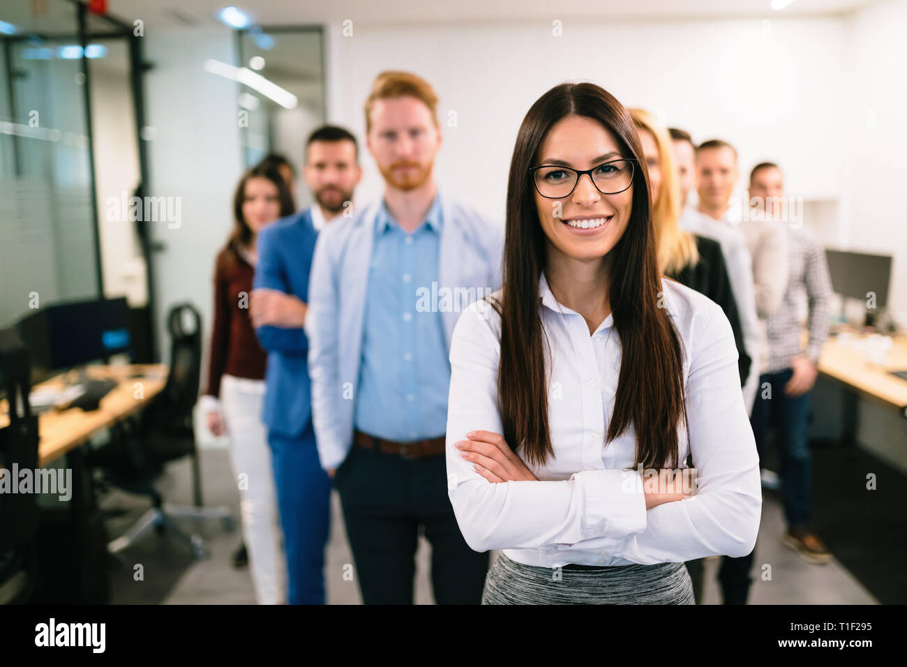 Portrait of business team posing in office Stock Photo - Alamy