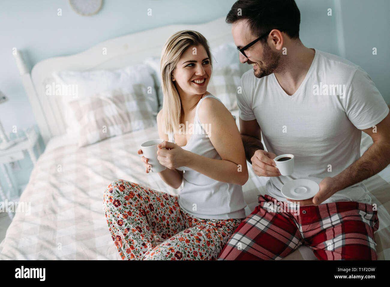 Portrait of young loving couple in bedroom Stock Photo