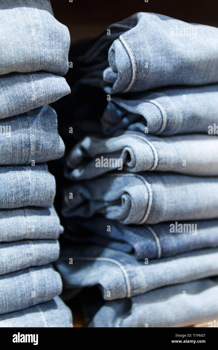stack of clothes jeans pants on display stand Stock Photo - Alamy