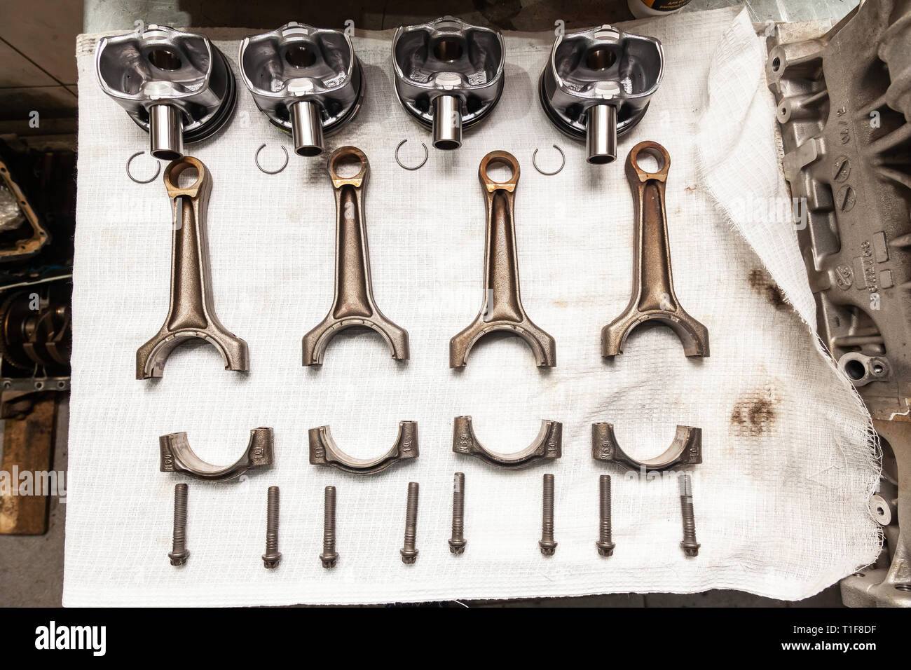 Engine connecting rods and pistons used and removed from a four