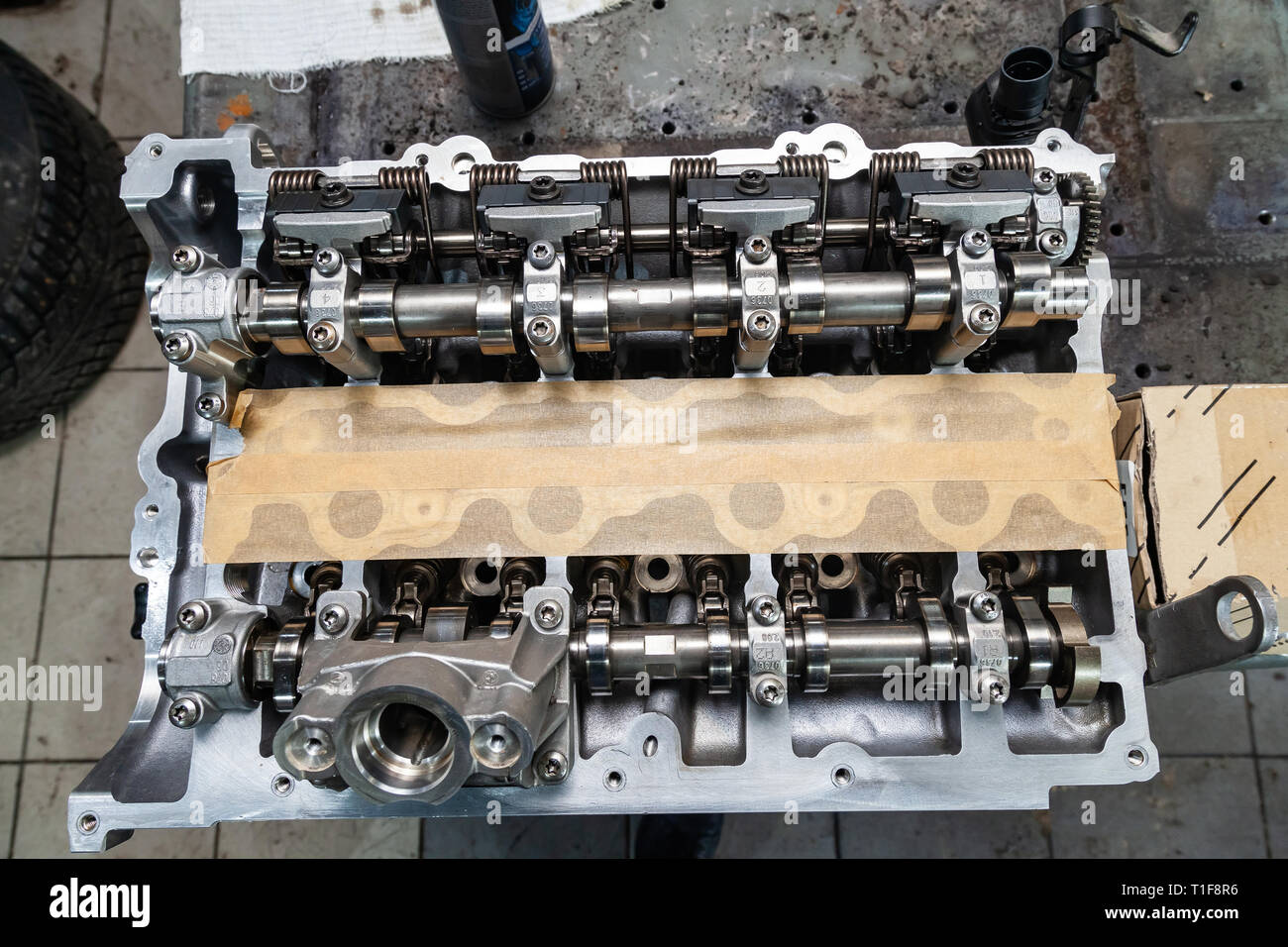 A four-cylinder engine with new camshaft dissembled and removed from car on a workbench in a vehicle repair workshop. Auto service industry. Stock Photo