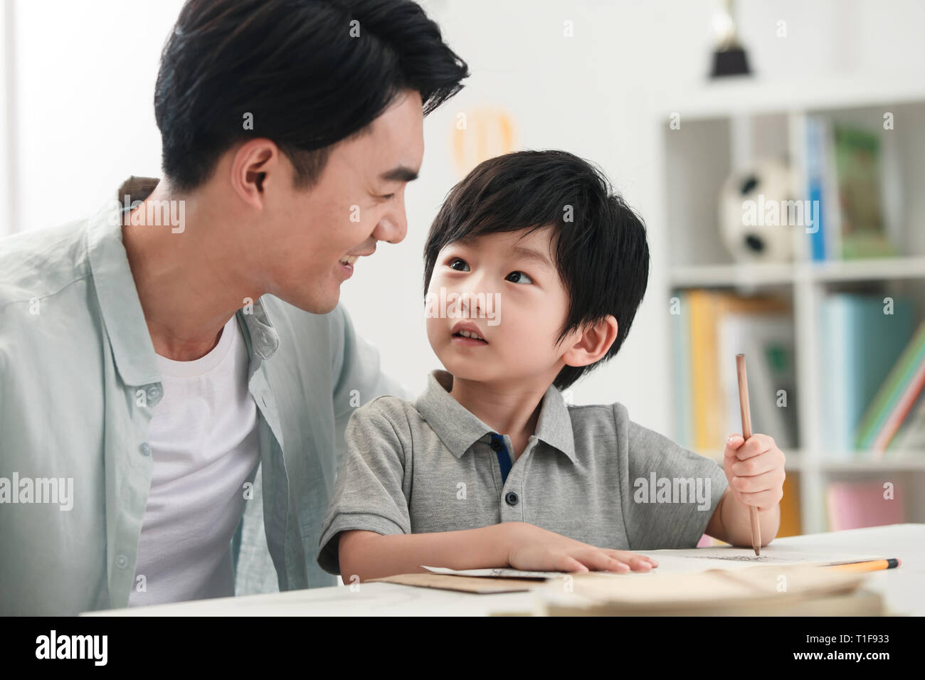Dad counselling son do his homework Stock Photo