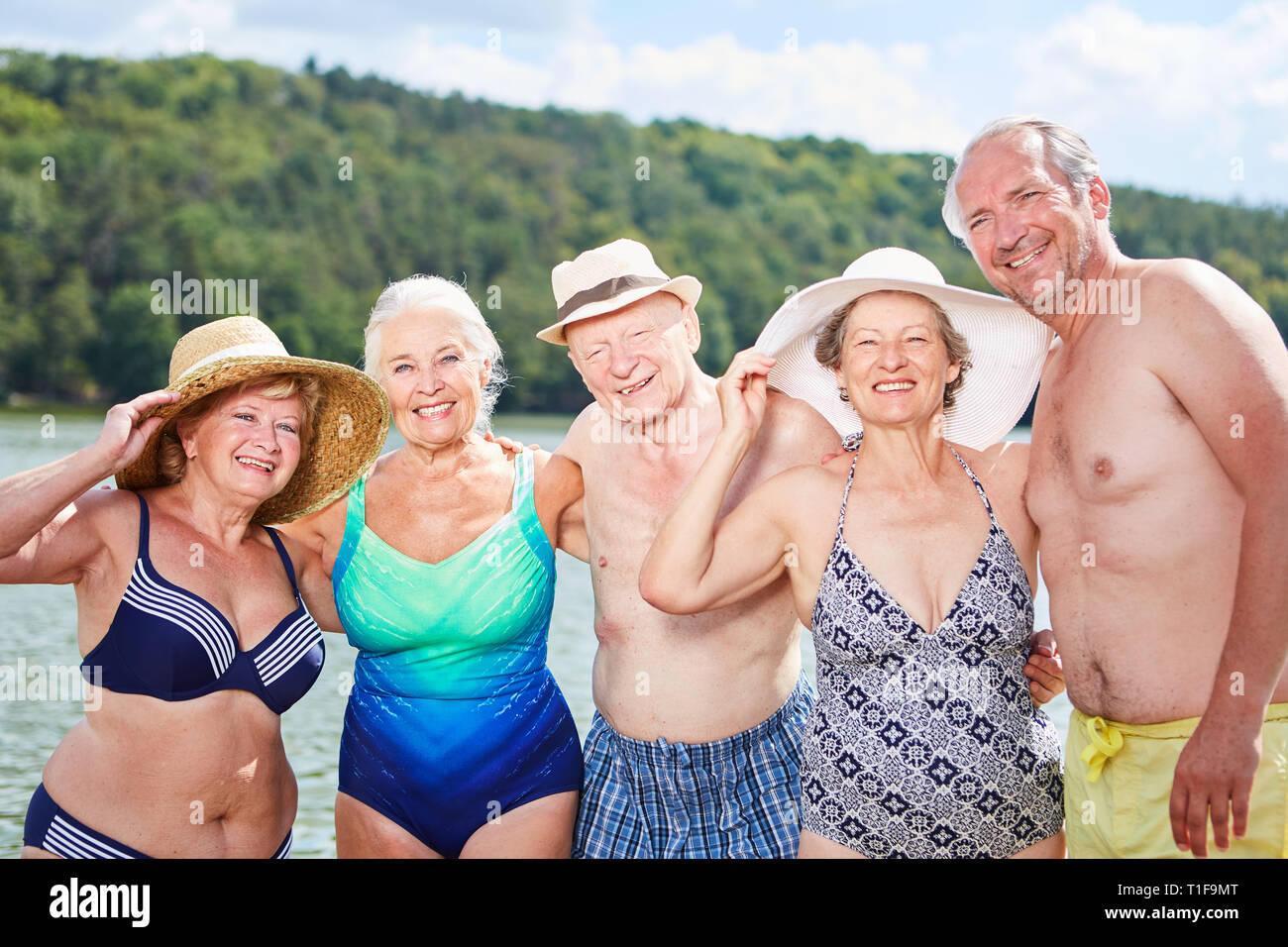 Laughing group of seniors bathing at the lake in summer Stock Photo