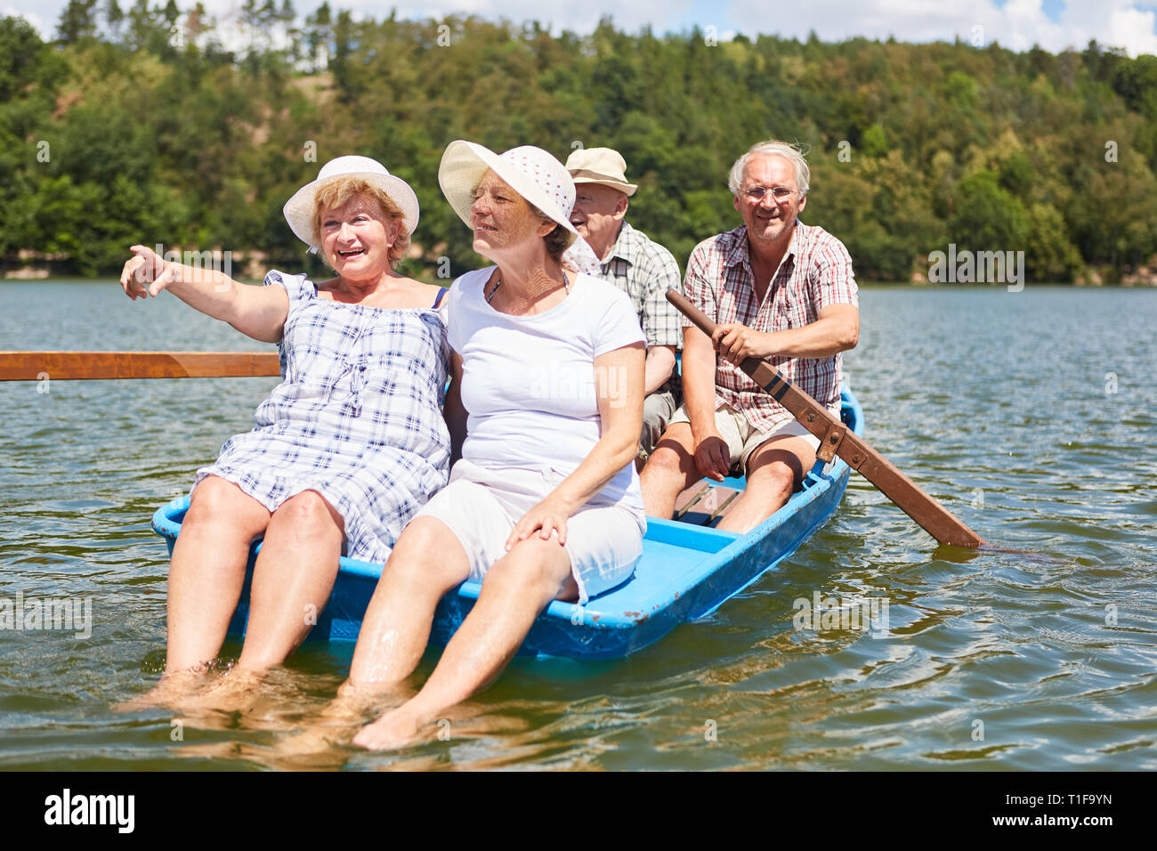 Senior group makes a trip in the rowboat on the lake as a rest Stock Photo