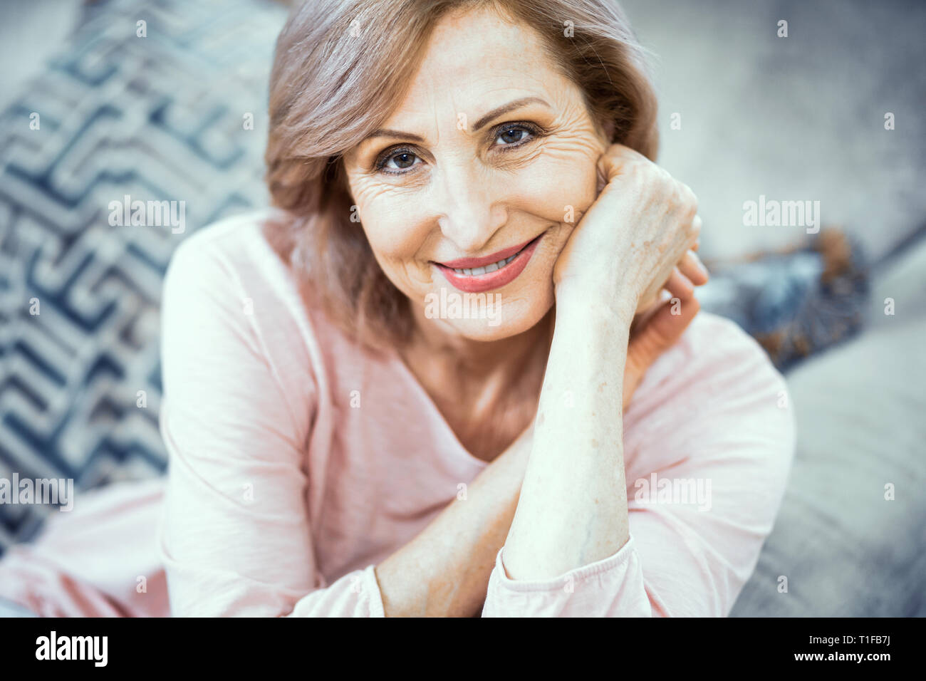 Attractive middle aged woman relaxing at home Stock Photo Alamy