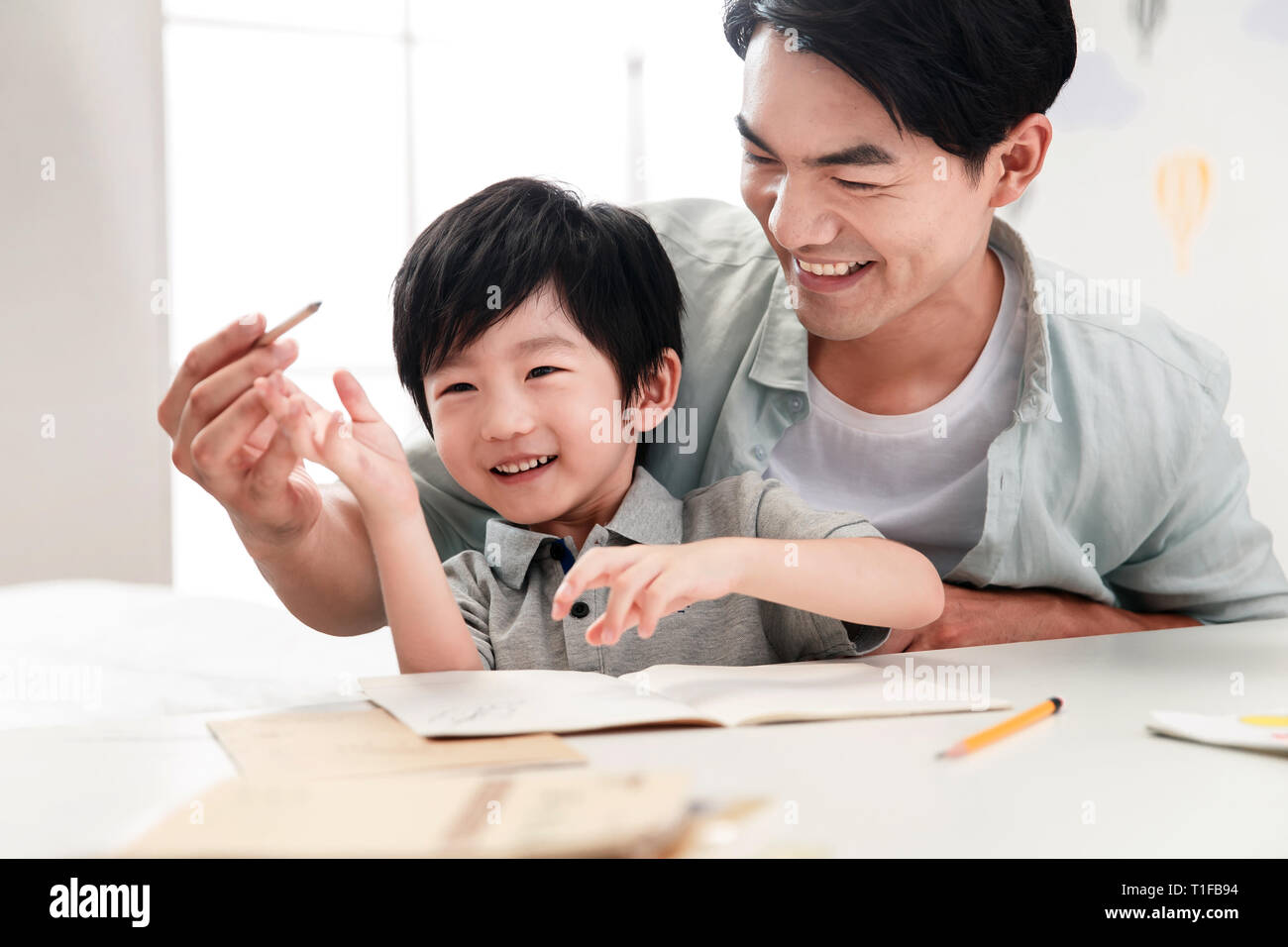 Dad counselling son do his homework Stock Photo