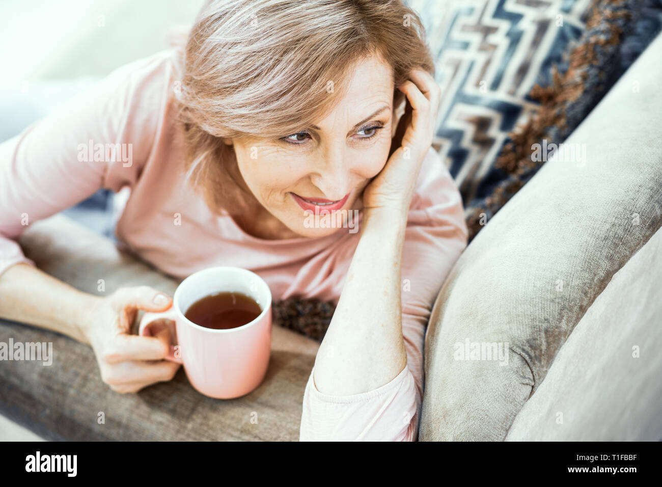 Attractive middle aged woman relaxing at home Stock Photo