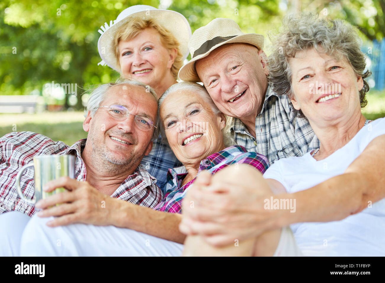 Happy seniors group as friends on a tour in summer in nature Stock Photo