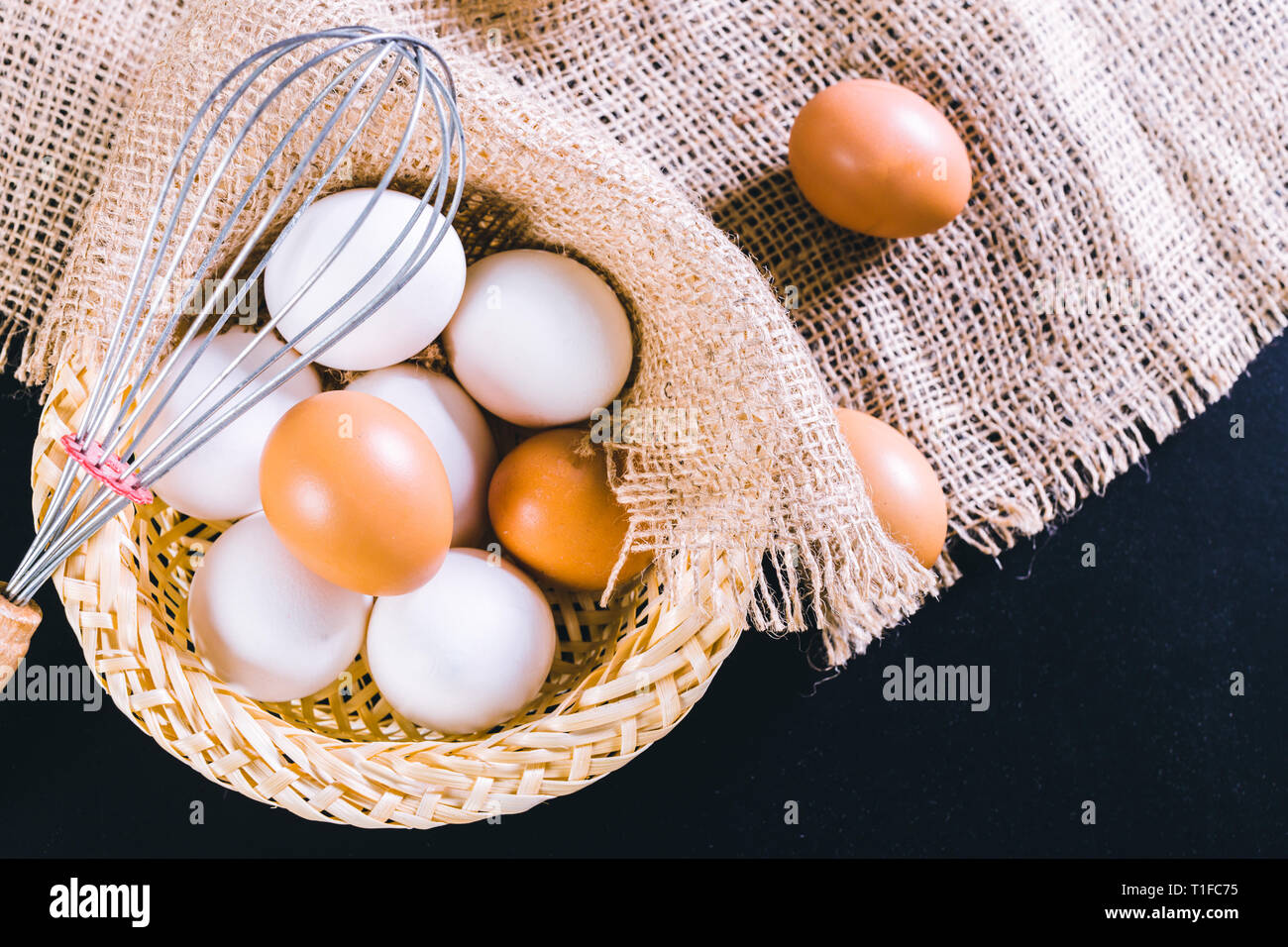 Eggs on tablecloth over black background Stock Photo