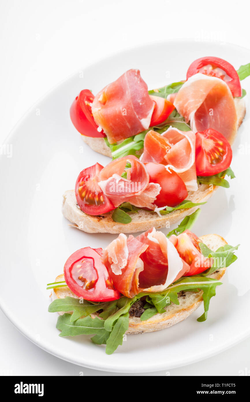 Jamon. Slices of Bread with Spanish Serrano Ham Served as Tapas. Cured ham,  spanish appetizer. Prosciutto isolated on white background Stock Photo -  Alamy