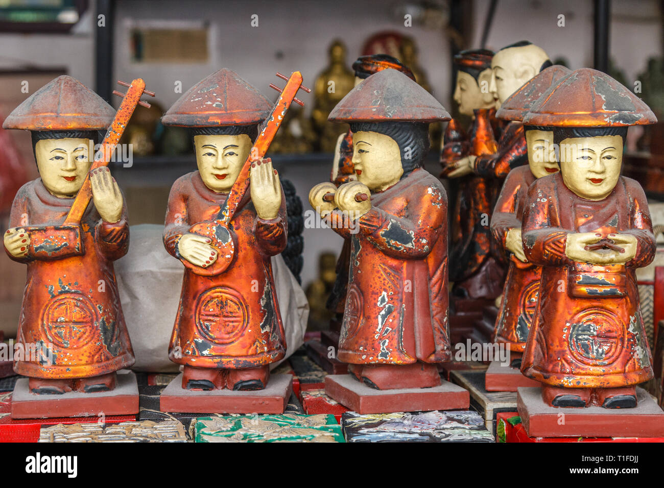 Souvenir wooden dolls of playing music instruments at a street stall in Old Quarter, Hanoi, Vietnam. Stock Photo