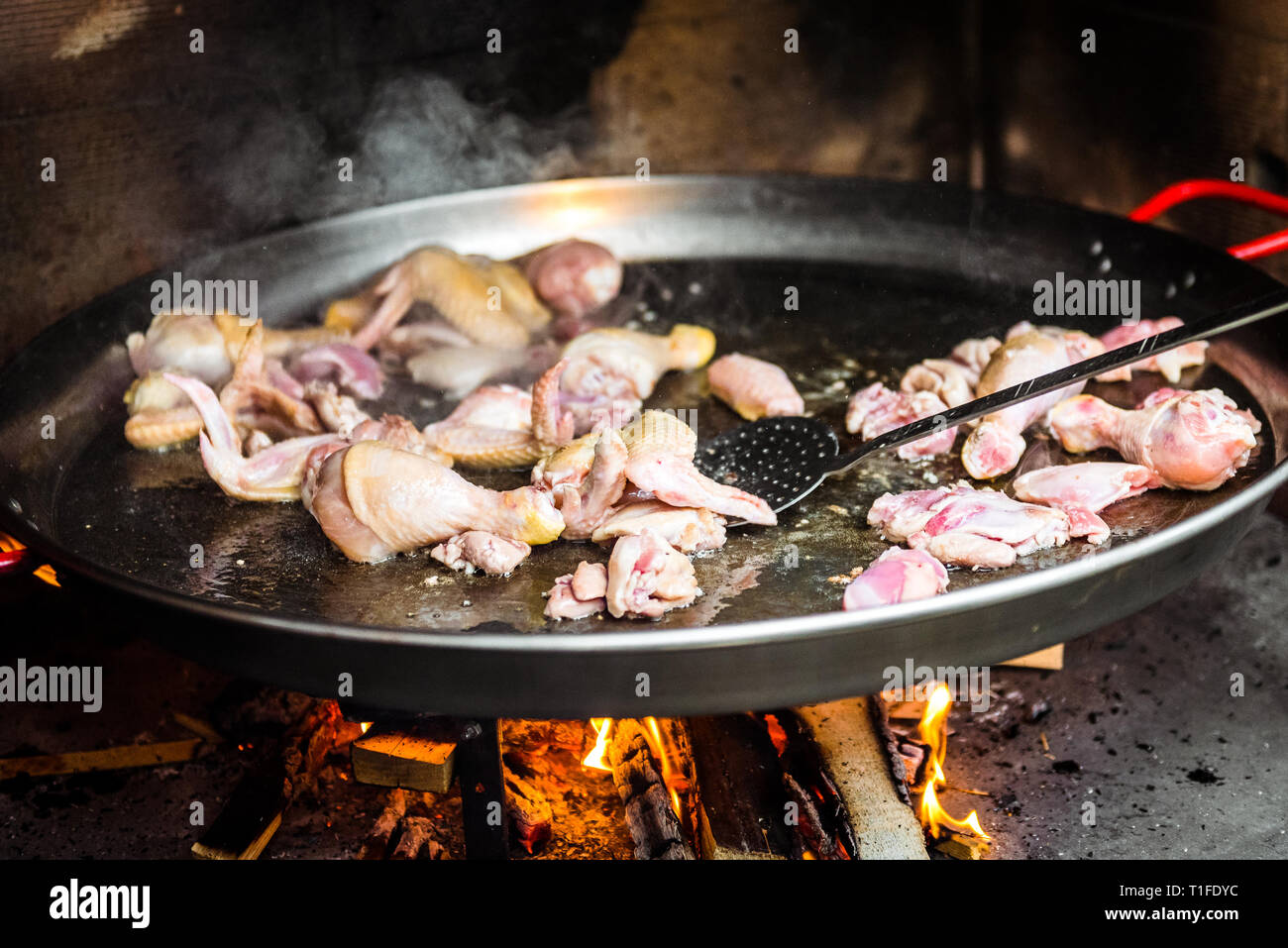 Cooking and making a traditional Spanish Paella over open fire