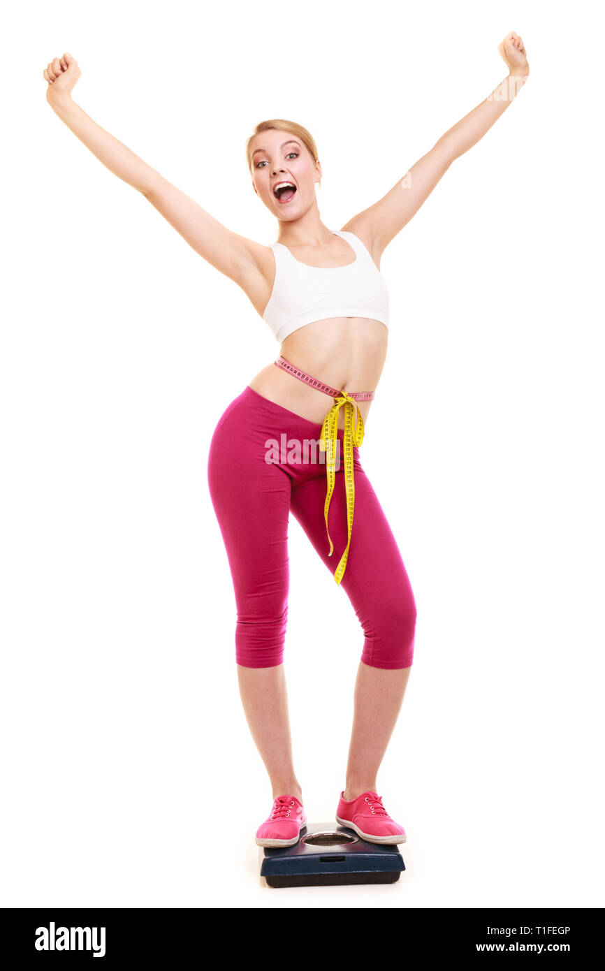 Slimming and weight loss. Happy joyful young woman girl measuring with