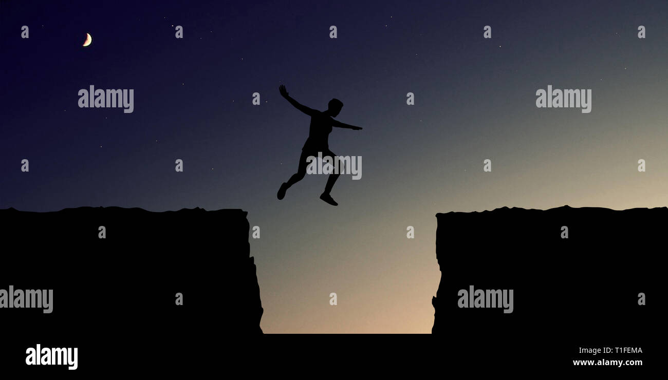 Courage for risk and motivation Concept with sport and fitness People jumping over a canyon Stock Photo