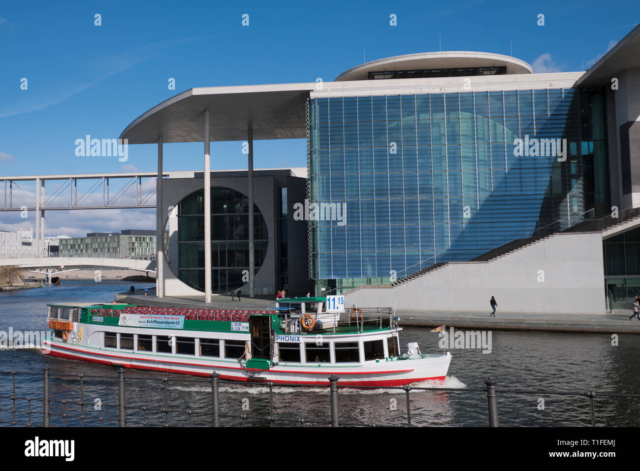 Tourist boat passes  in front of the Marie Elizabeth Lueders Building in Berlin Germany Stock Photo