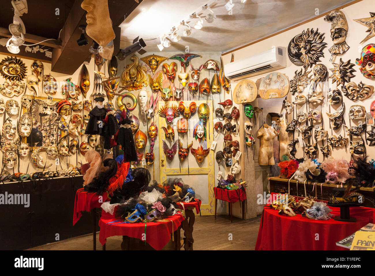 Colourful display of Venetian Carnival masks in Ca' Macana  shop in Dorsoduro, Venice, Veneto,  Italy specialising in painting your own designs Stock Photo
