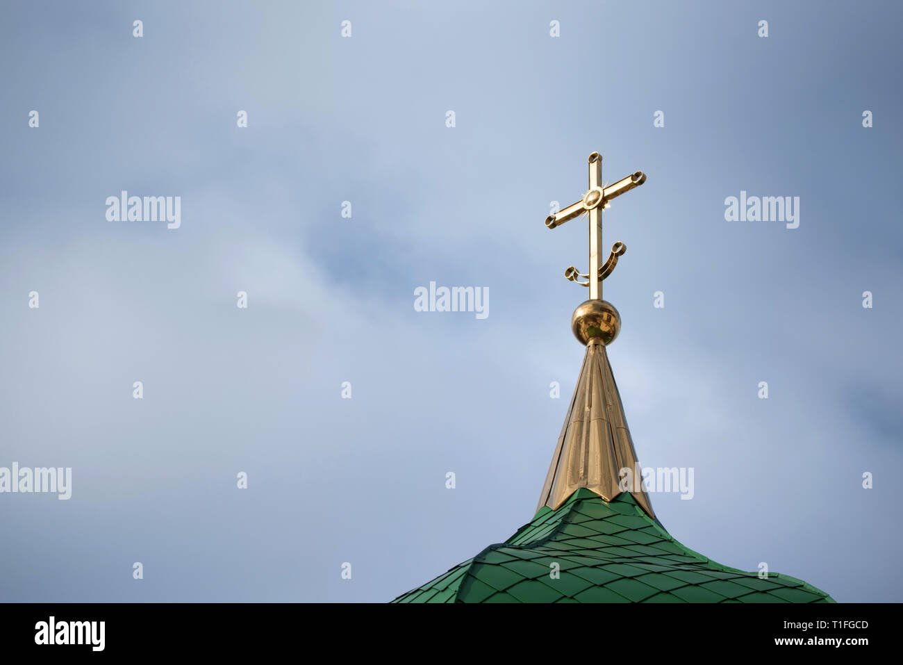 Orthodox cross with crescent at church rooftop against sky Stock Photo