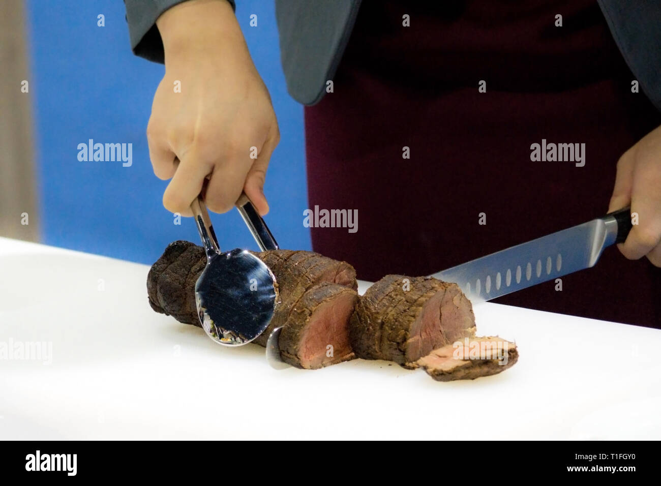Roast beef and slice, chef's hands cutting roast beef, Carving roast