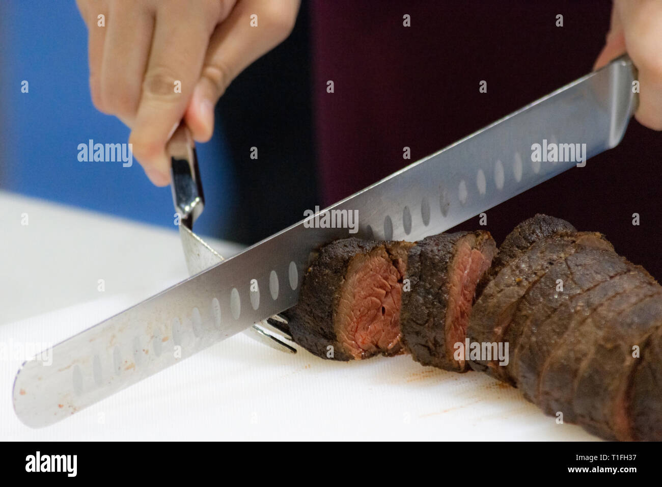 Roast beef and slice, chef's hands cutting roast beef, Carving roast