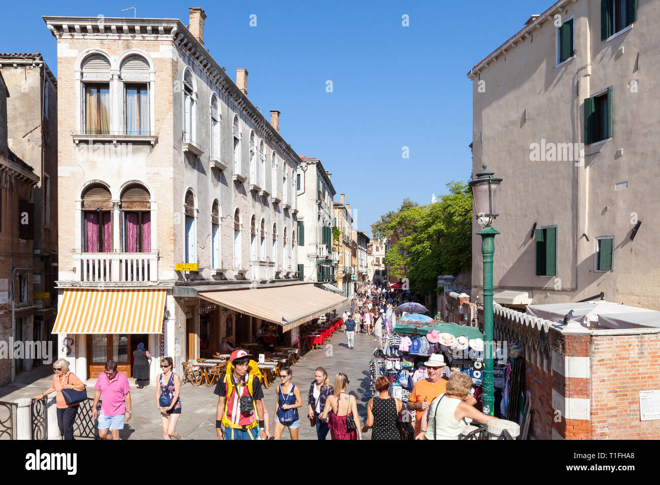 Street scene in Strada Nova, Cannaregio, Venice, Veneto, Italy with people walking, shops and restaurants in historic buildings. Thoroughfare from sta Stock Photo