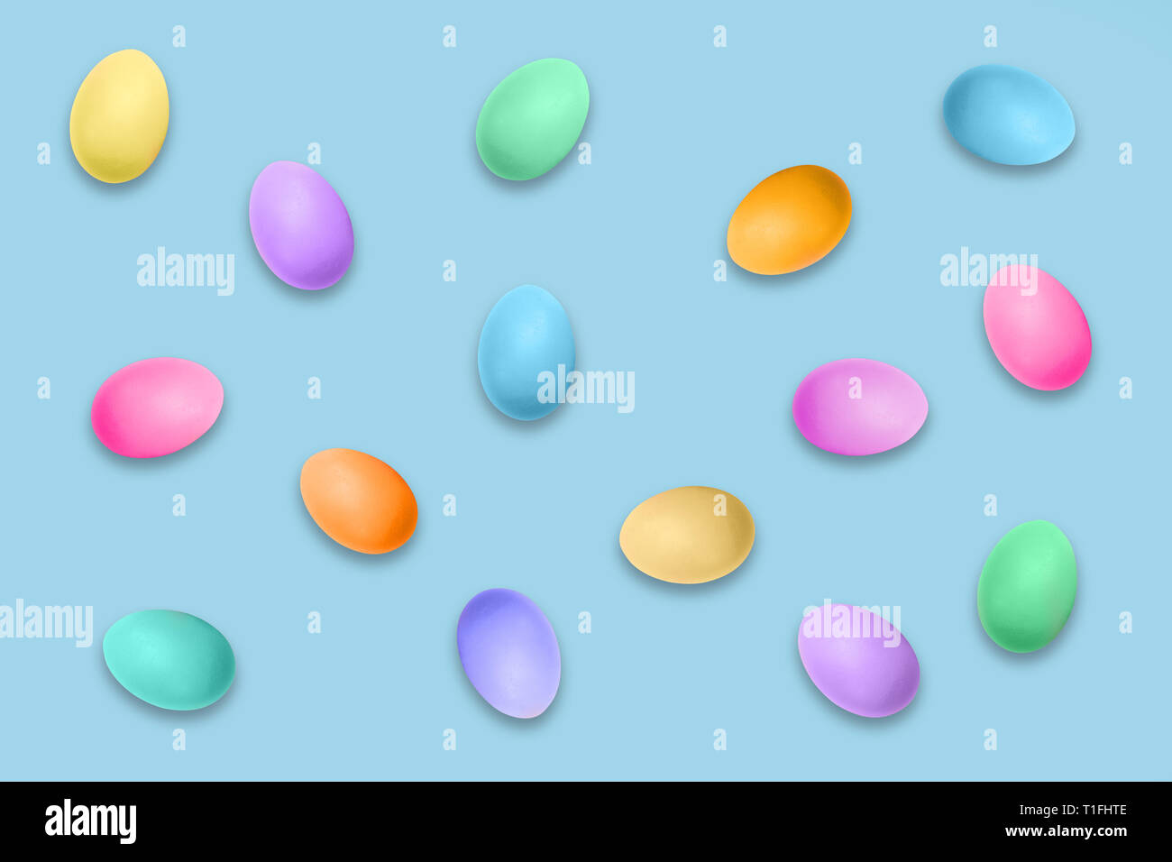 Pastel colored Easter eggs on blue background, Easter pattern Stock Photo