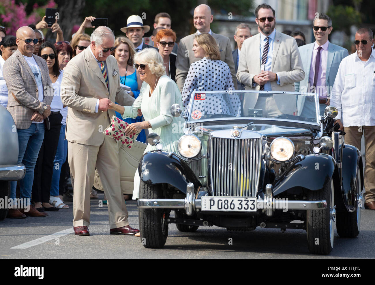 The Prince of Wales helps the Duchess of Cornwall out of an MG TD sportscar from 1953 as they arrive at a British Classic Car event in Havana, Cuba, as part of an historic trip which celebrates cultural ties between the UK and the Communist state. Stock Photo