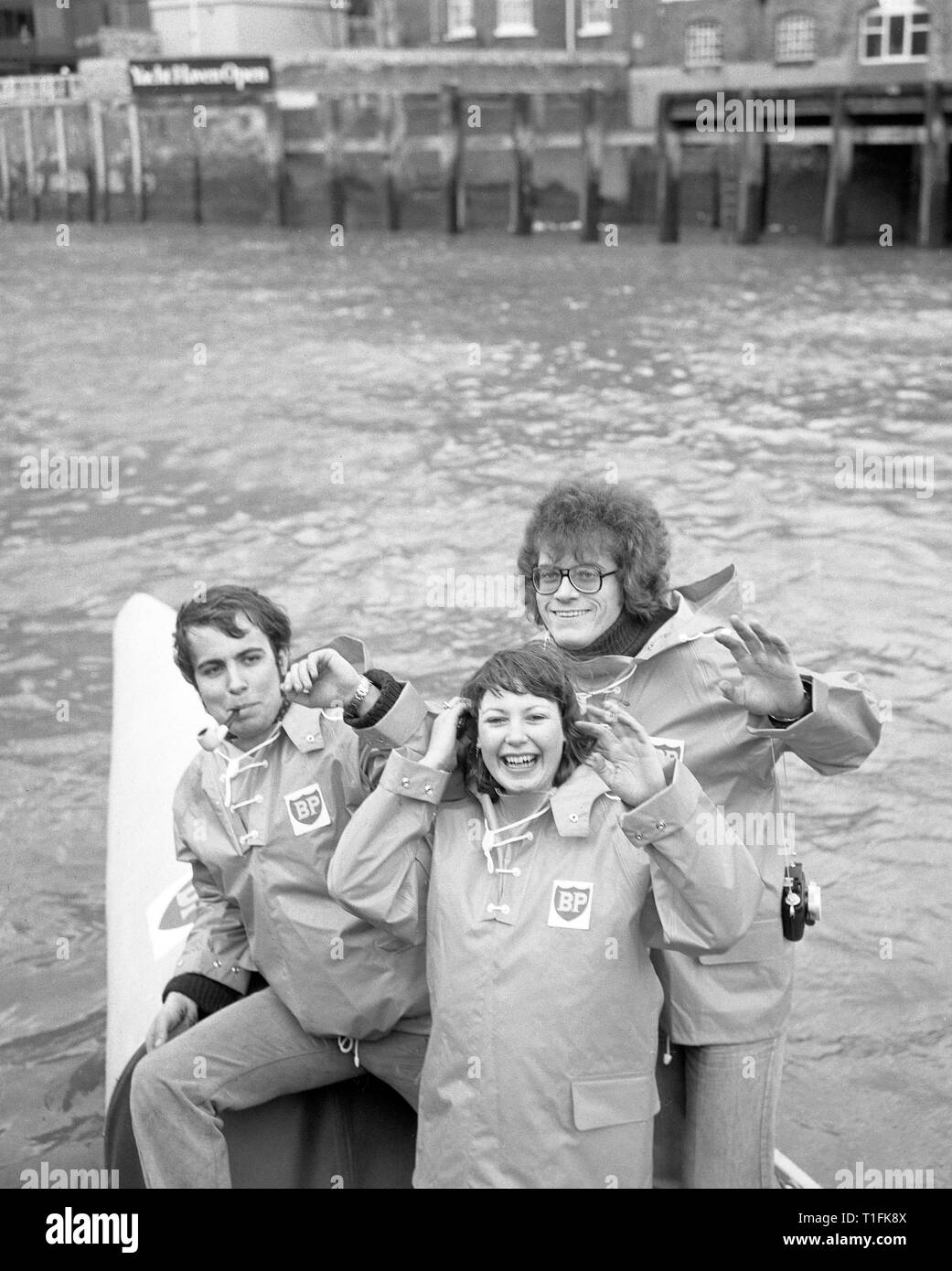(L-R) Derek King, 24, Carol Maystone and Peter Bird, 26, in their oilskins in London. They are set to attempt to row round the world in Britannia II , the Uffa Fox designed boat that John Fairfax and Sylvia Cook rowed across the Pacific in 1972. The team will start their attempt from Gibraltar later this month. Stock Photo