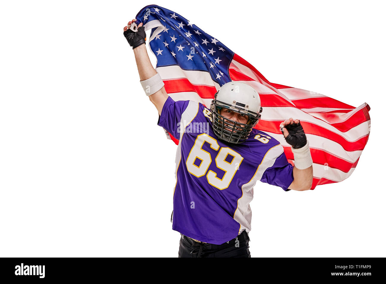 Football Player with uniform and a american flag celebrates victory, on