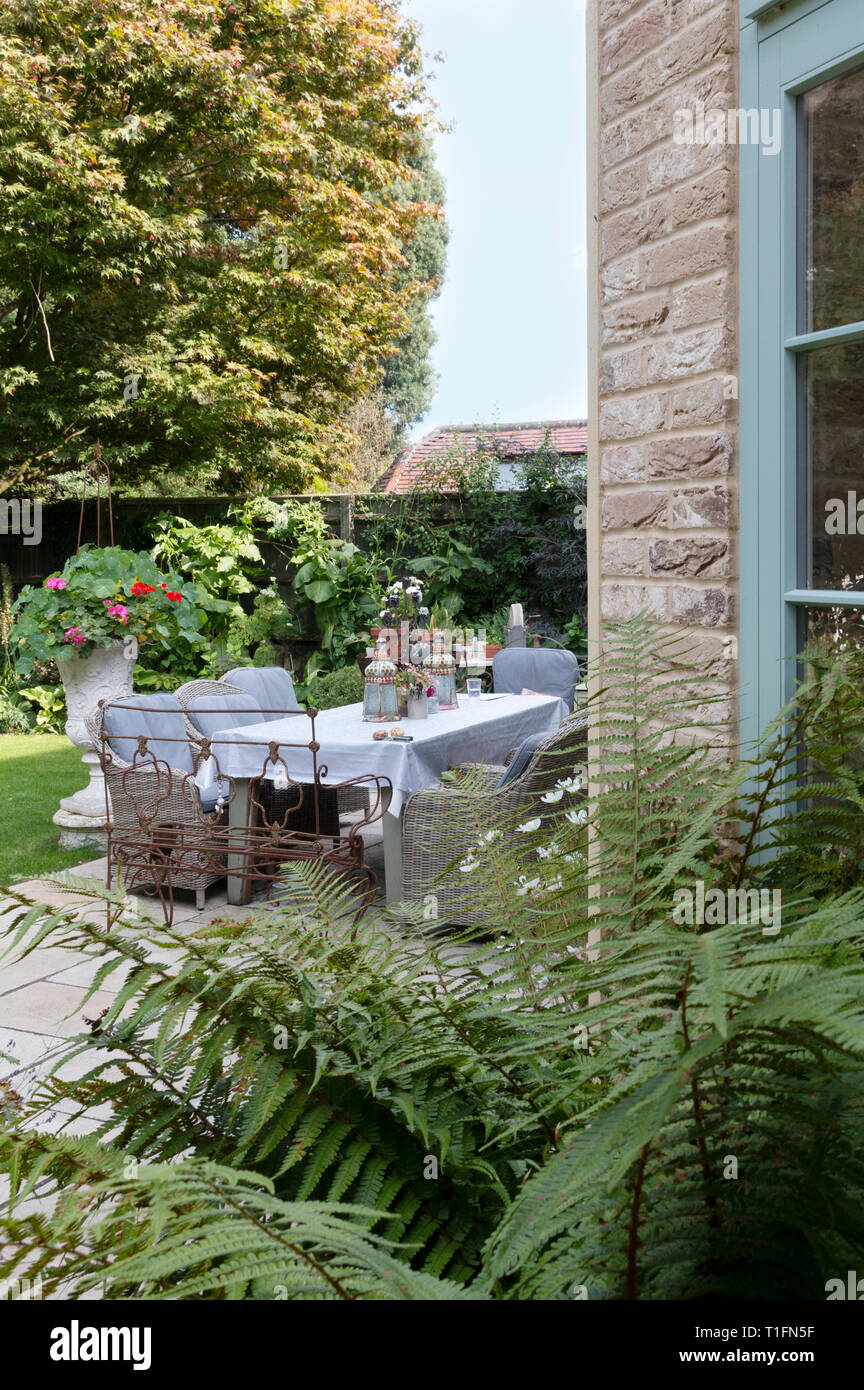 Garden dining table set for a dinner party Stock Photo