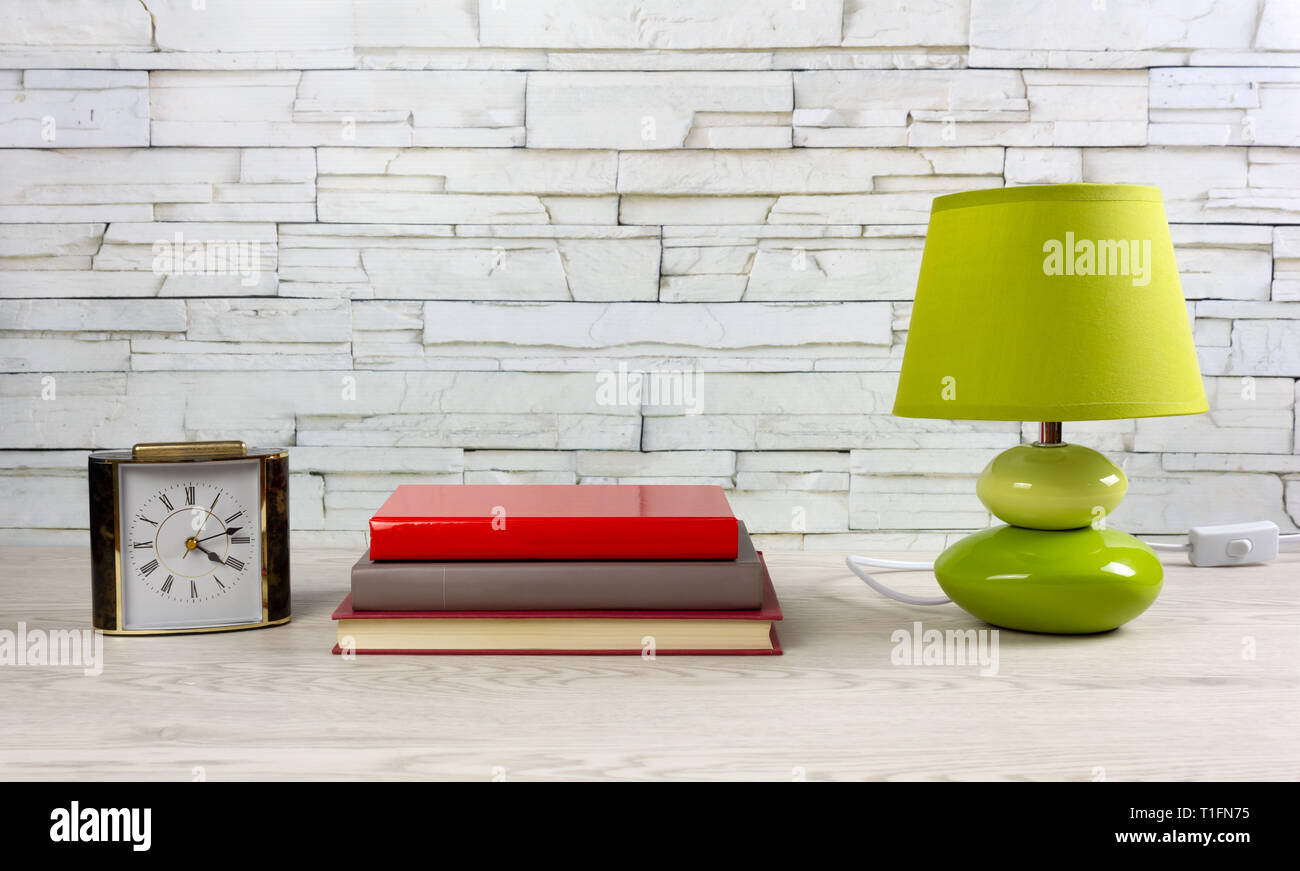 White Wooden Desk With A Few Books A Modern Green Lamp And A Classic Table Clock Stock Photo Alamy