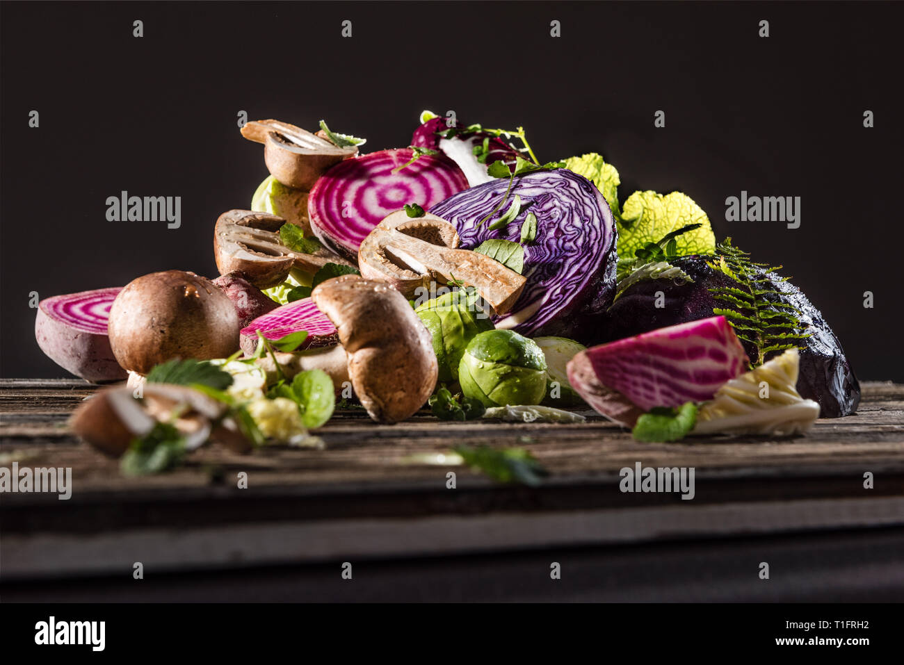 A pile of mushroom vegetables, beetroot and Brussels sprouts in studio light. Stock Photo