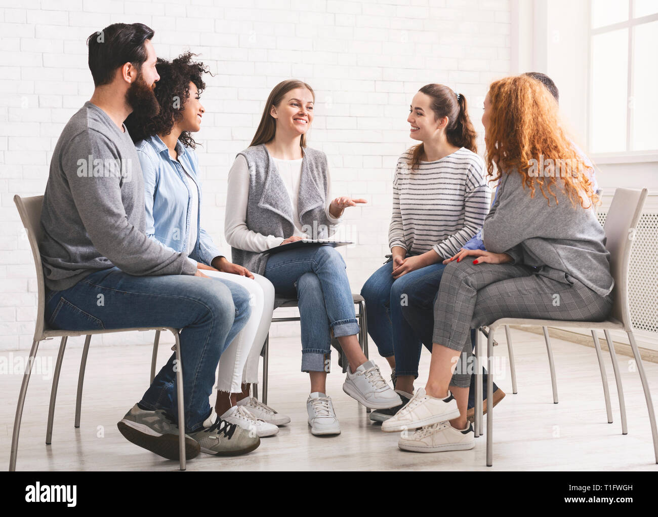 Therapist speaking to rehab group at therapy session Stock Photo