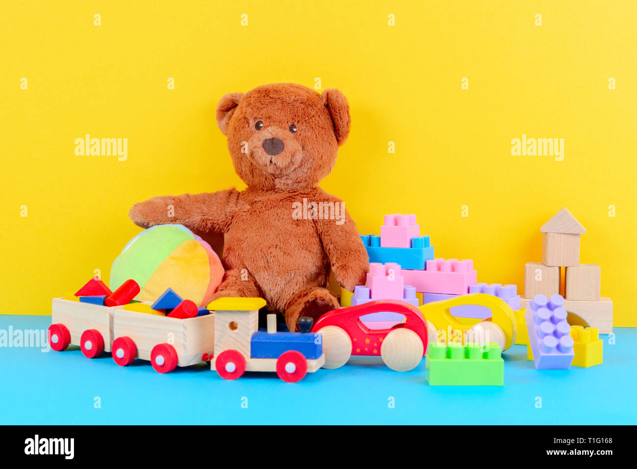 Baby kid toys collection on blue and yellow background Stock Photo Alamy