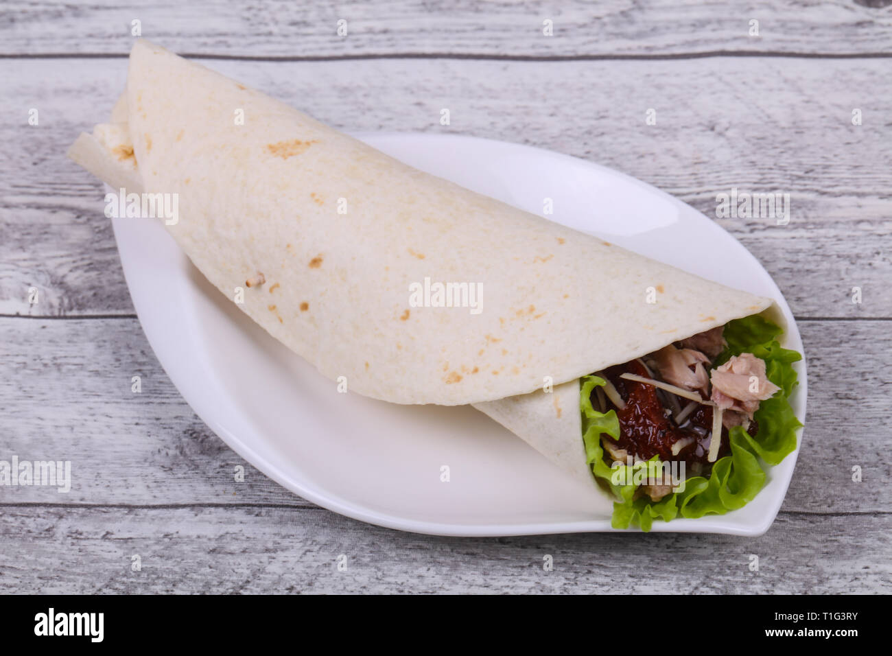 Tortilla with tuna, salad, cheese and dried tomato Stock Photo Alamy
