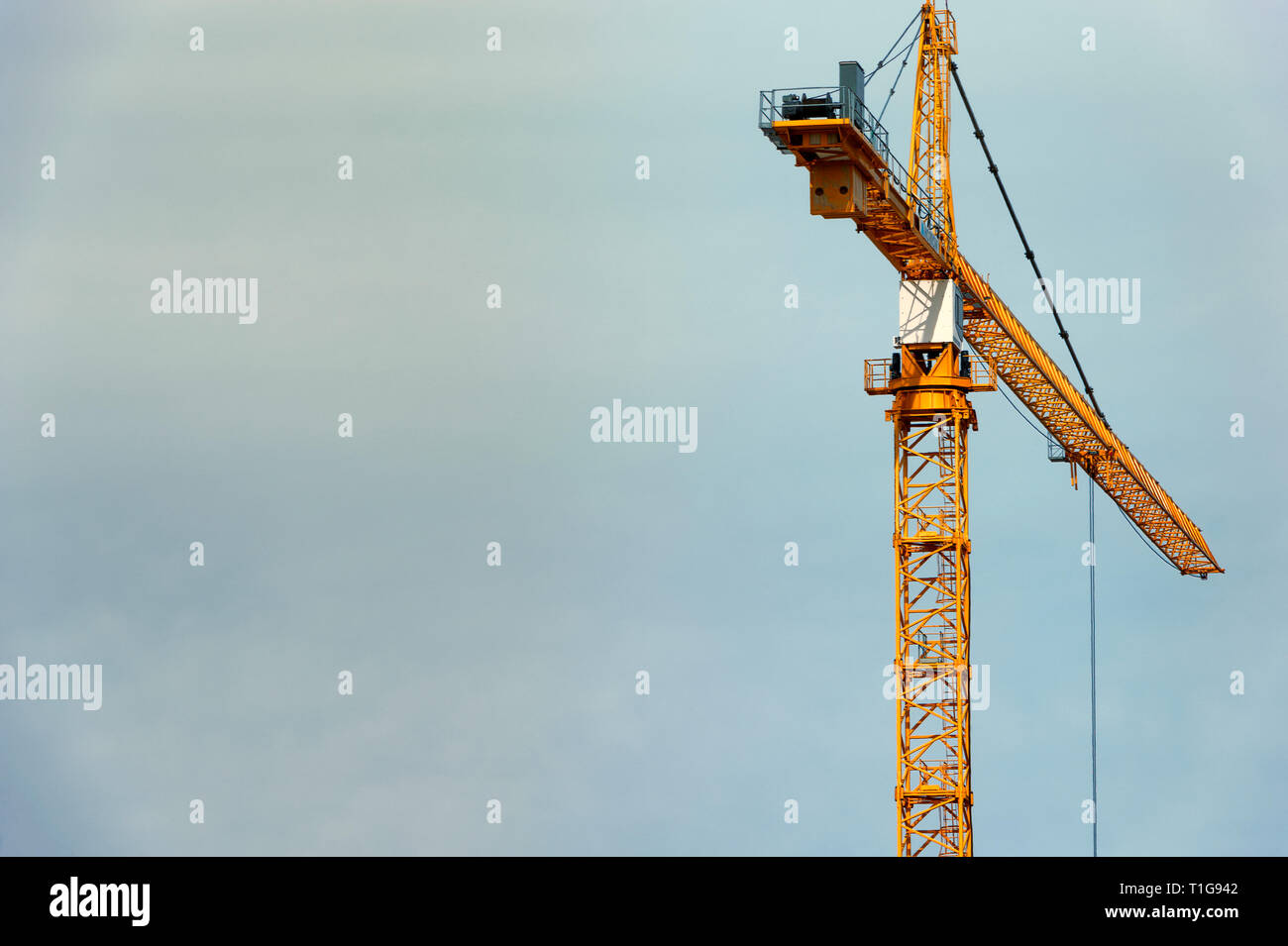 Construction crane high in a cloudy sky with copy space Stock Photo - Alamy