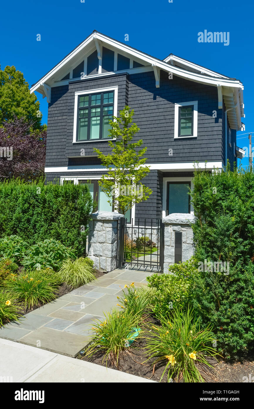 Stone tile paved pathway leading to the entrance door through metal