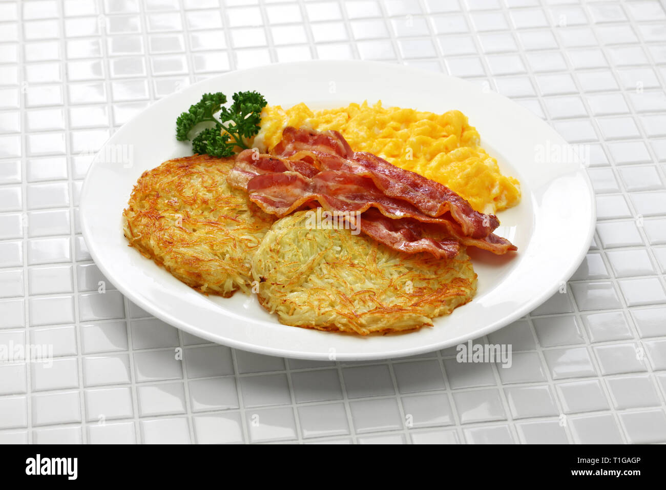 diner style hash browns, scrambled eggs and bacon Stock Photo Alamy