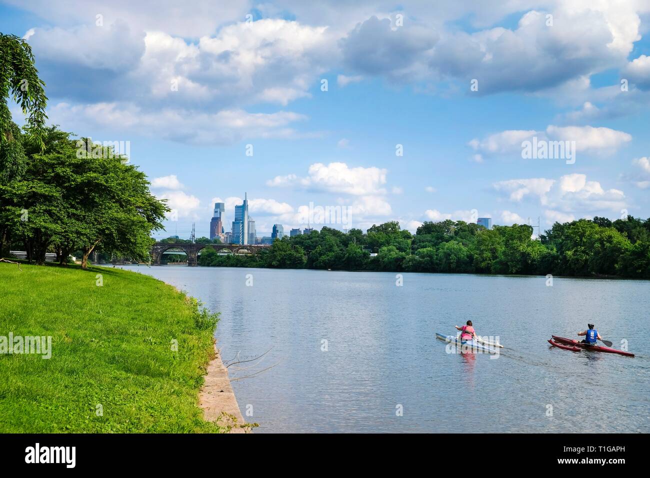 Friends Kayaking on Schuylkill River in Fairmount Park with Skyline in background, Philadelphia, Pennsylvania. Stock Photo