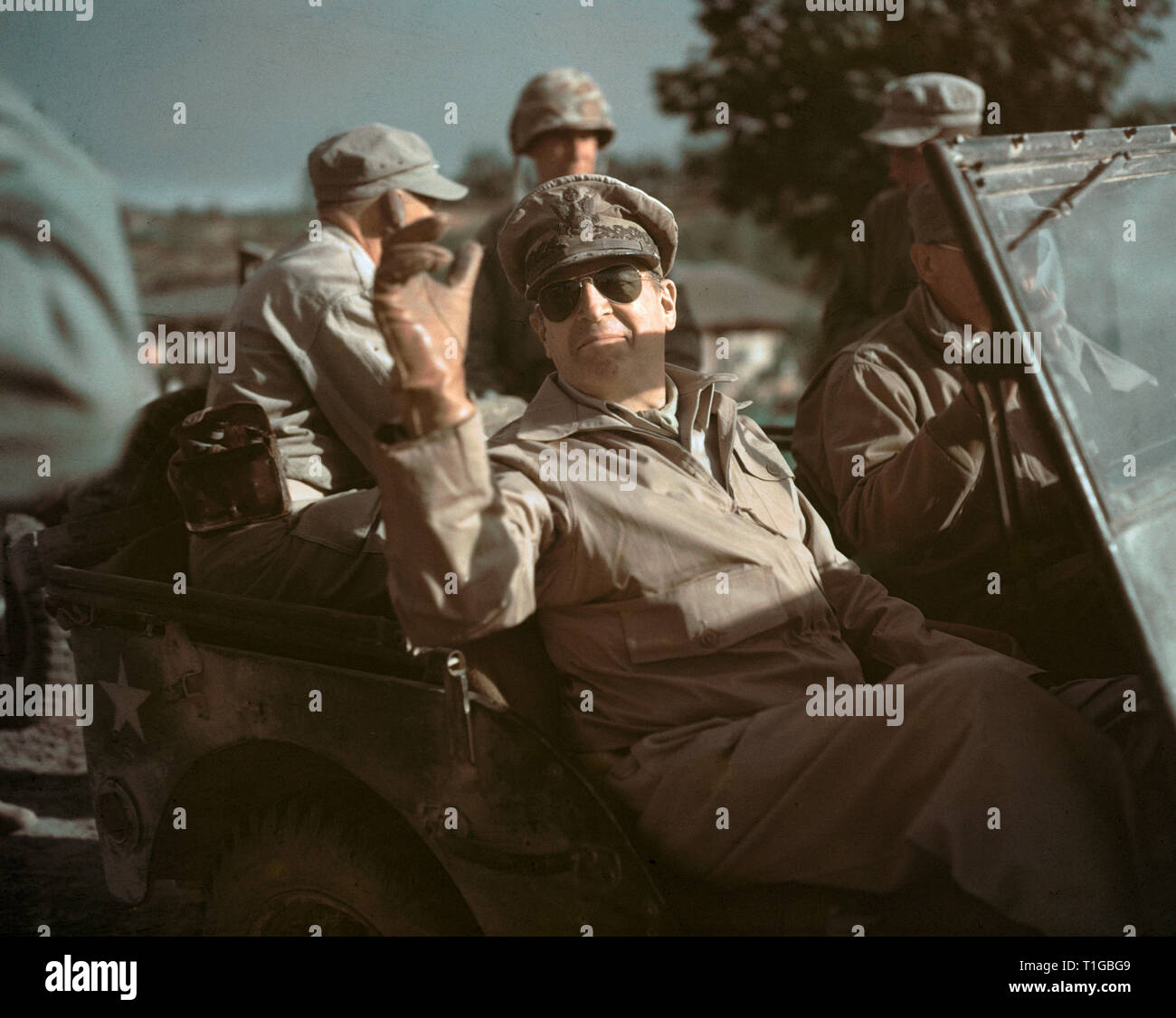 General Douglas MacArthur waving while Riding in a Jeep,  (1950), Seoul, South Korea  File Reference # 1003_737THA Stock Photo