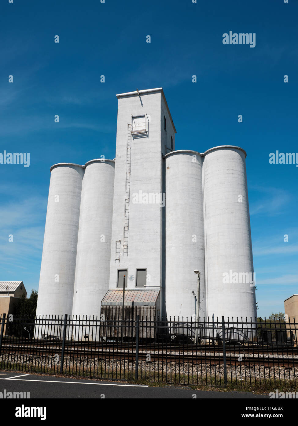 Tall or large grain silos along the railroad or train tracks in Montgomery Alabama, USA. Stock Photo