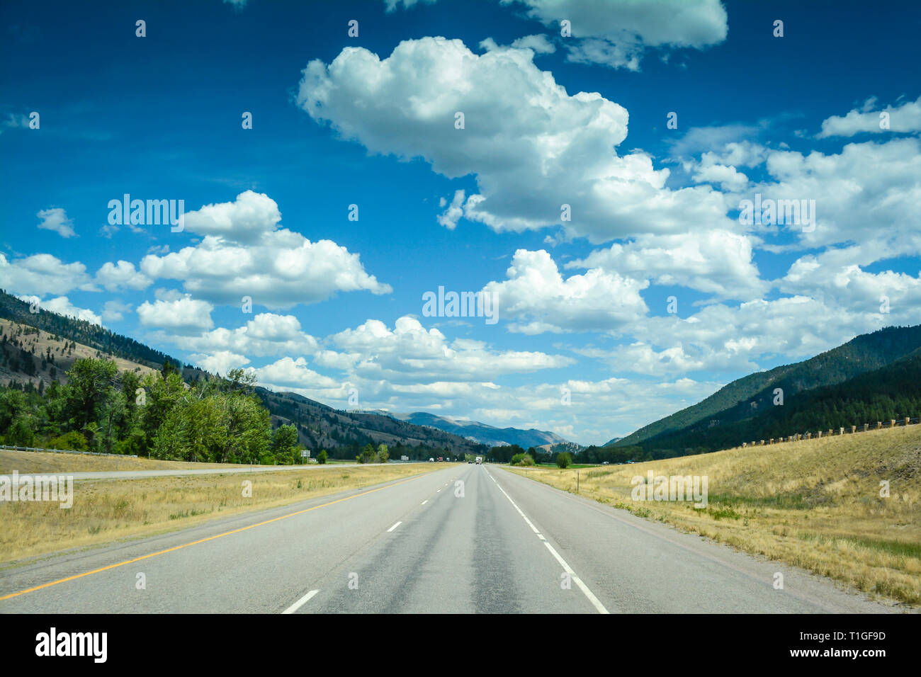 A big sky country view of interstate I-90 traveling in Southwest Montana near Rock Creek Recreation Area on a beautiful day Stock Photo