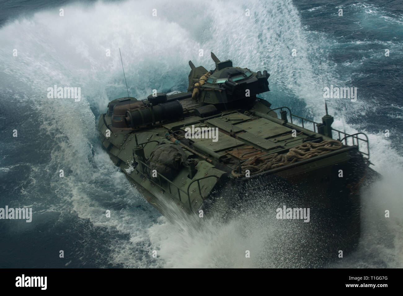 An Assault Amphibious Vehicle with Battalion Landing Team, 1st Battalion, 4th Marines, splashes into the water off the amphibious transport dock USS Green Bay (LPD 20), underway in the Pacific Ocean, March 24, 2019. BLT 1/4 is the Ground Combat Element for the 31st Marine Expeditionary Unit. The 31st MEU, the Marine Corps’ only continuously forward-deployed MEU, provides a flexible and lethal force ready to perform a wide range of military operations as the premier crisis response force in the Indo-Pacific region. (Official Marine Corps photo by Lance Cpl. Cameron E. Parks /Released) Stock Photo