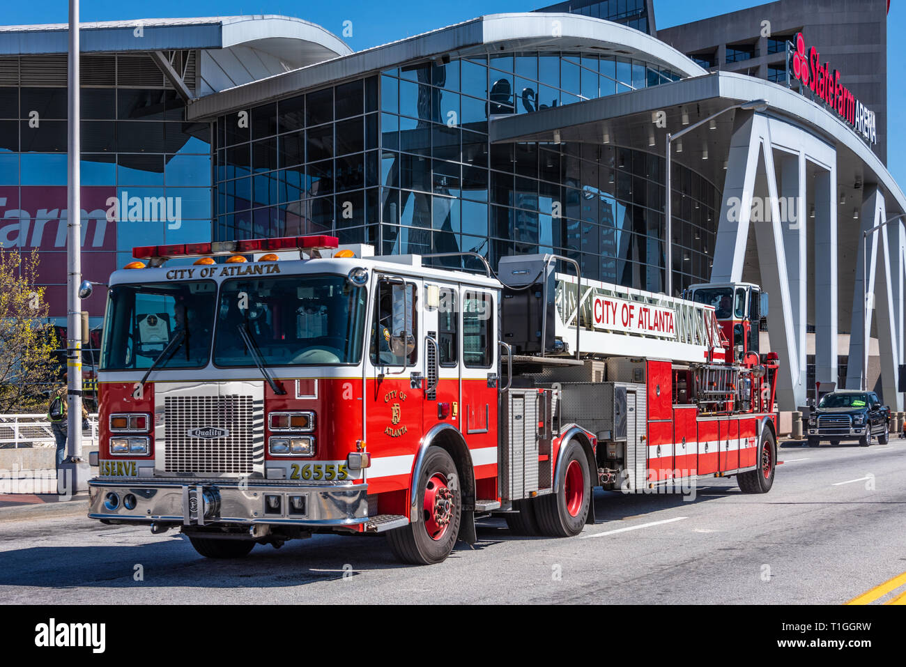 City of Atlanta fire engine ladder truck passing by State Farm Arena in downtown Atlanta, Georgia. (USA) Stock Photo
