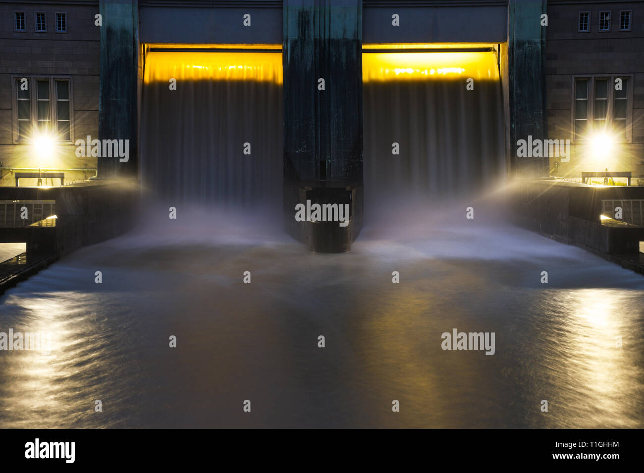 Small hydro dam electricity power station with beautiful sunset in