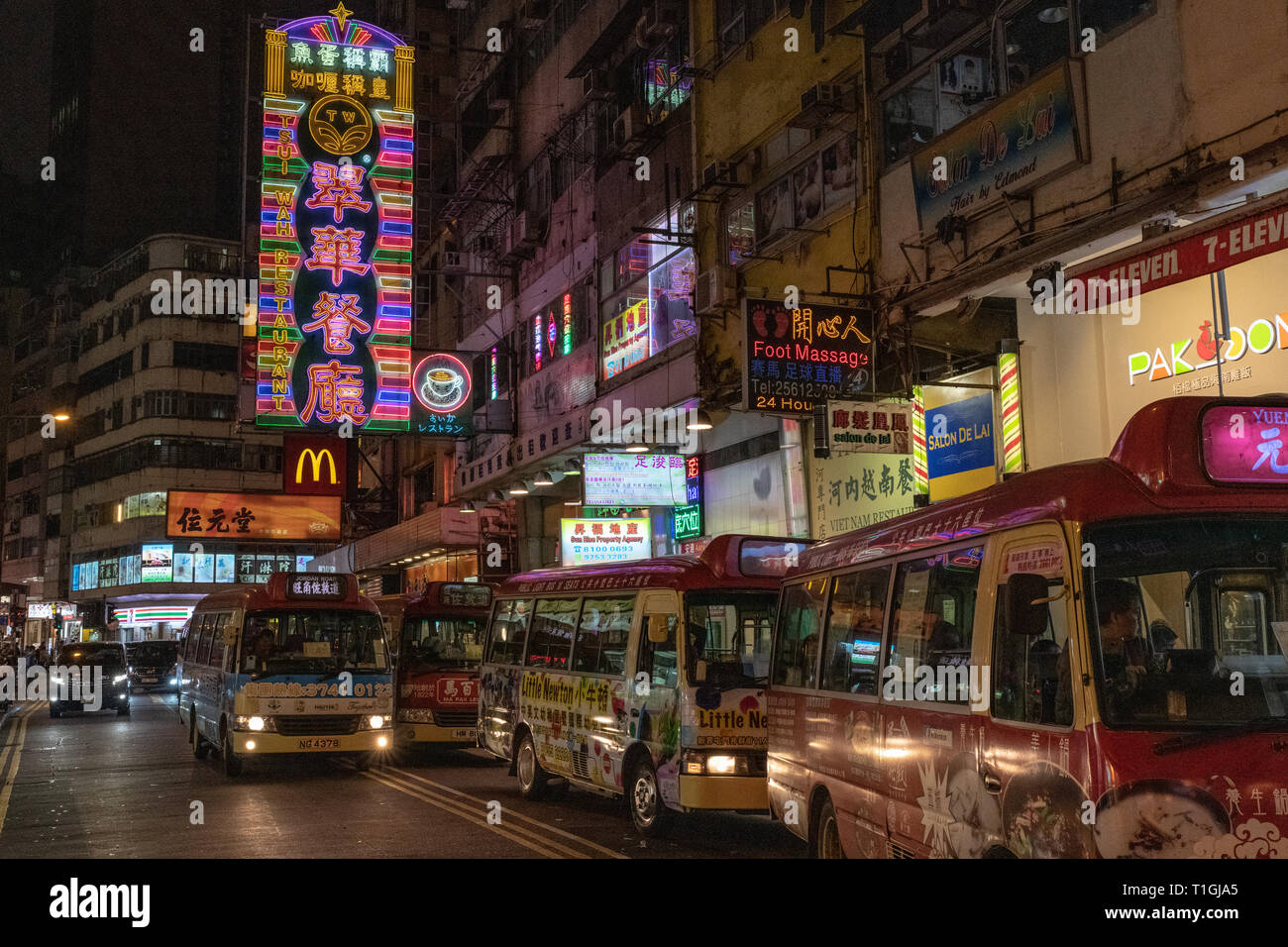 Buses and Street Signs at Night, Hong Kong Stock Photo