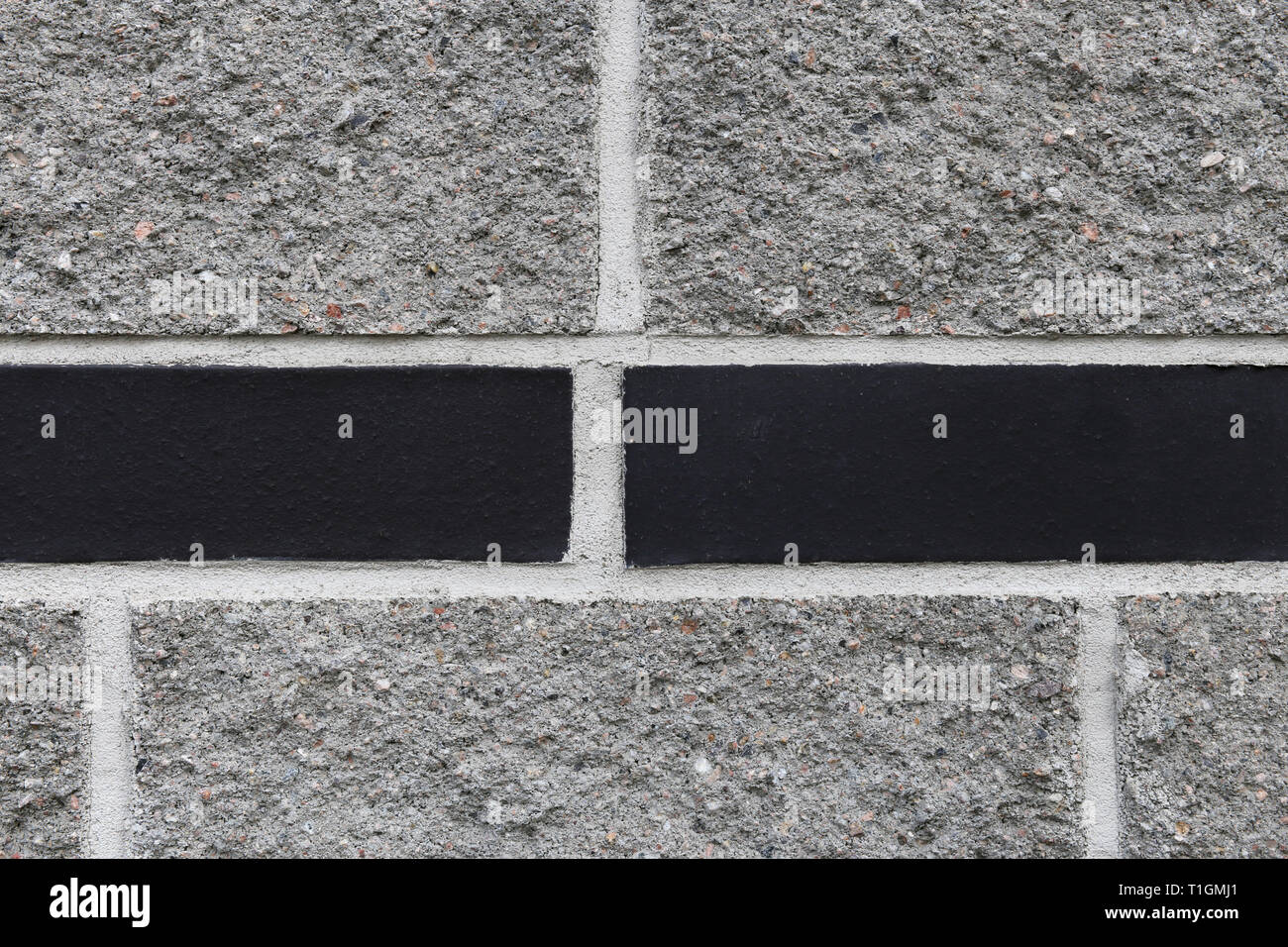 Black and grey brick wall. Texture of the exterior wall of a building